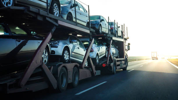 Auto carrier truck loaded with multiple vehicles traveling on highway during vehicle transport